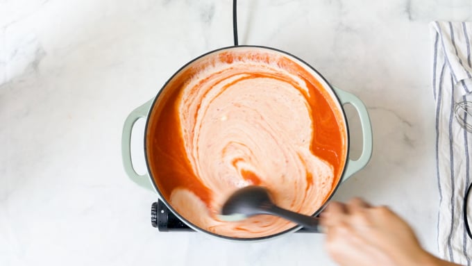 A pot of tomato soup with heavy cream 