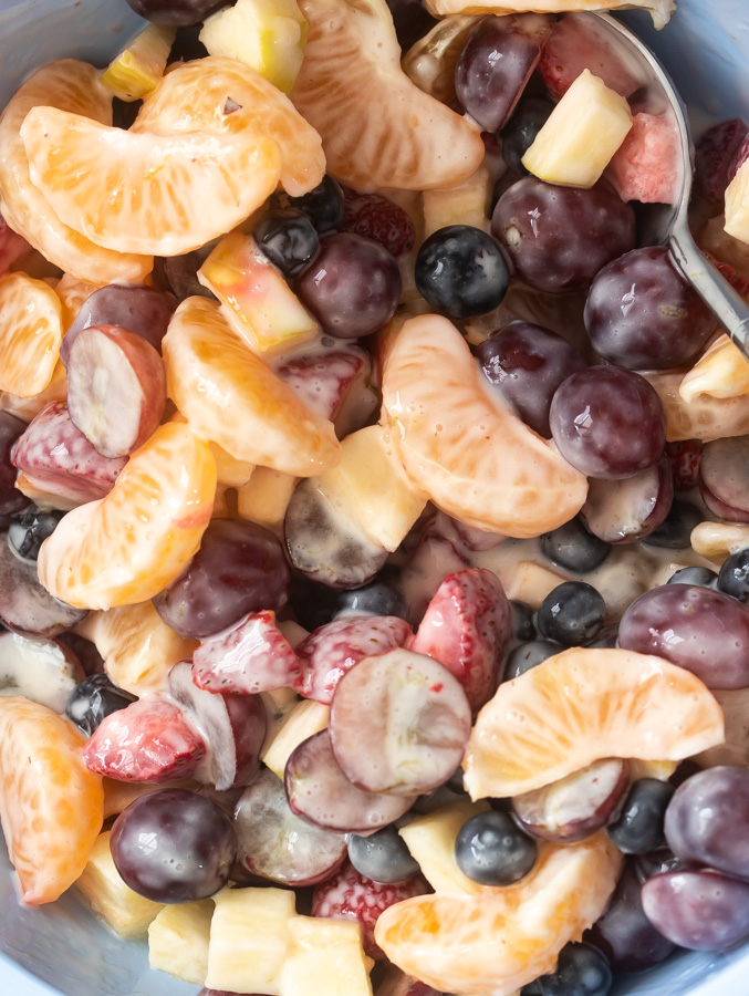 Creamy fruit salad with greek yogurt with fruit in a bowl