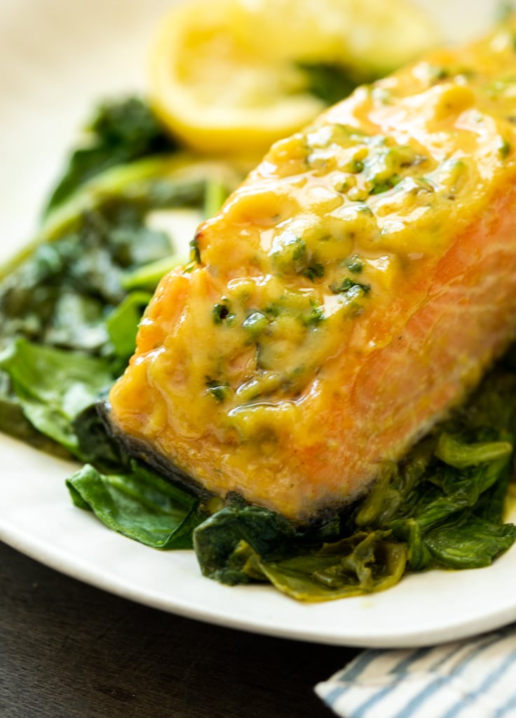 A picture of honey mustard salmon cooked in the oven with roasted spinach and honey mustard sauce