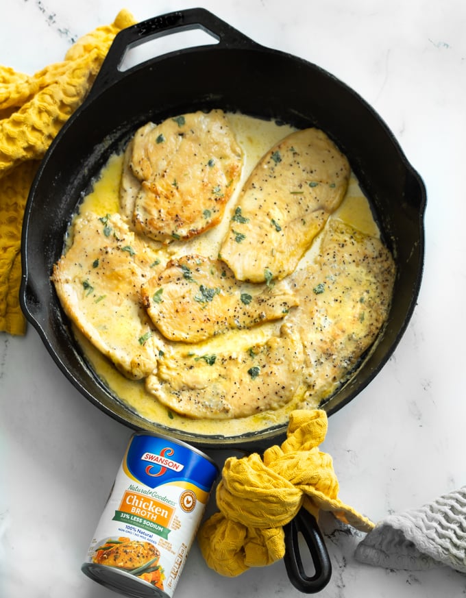 A picture of chicken in garlic cream sauce in a cast iron skillet