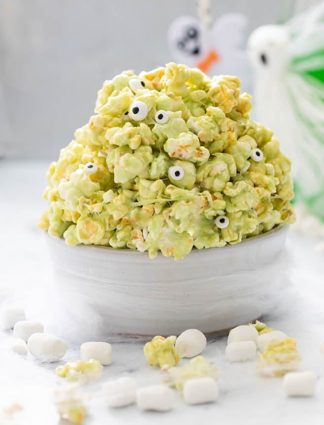 A picture of bowl of slime popcorn with candy eyeballs