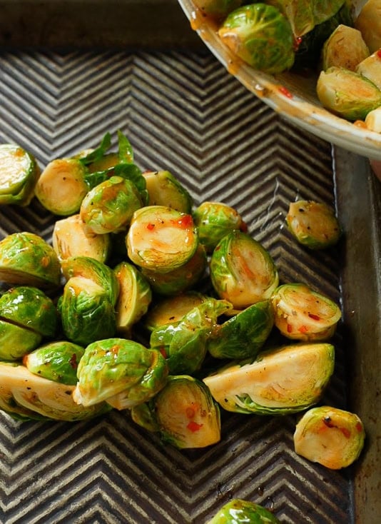 Brussels sprouts with sweet chili sauce in a pan to be roasted