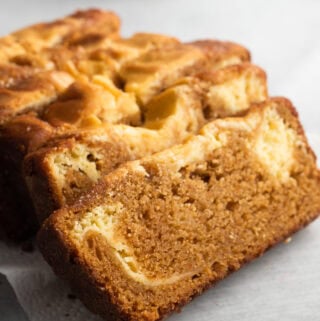 Slices of old fashioned sweet potato bread with cream cheese on a plate