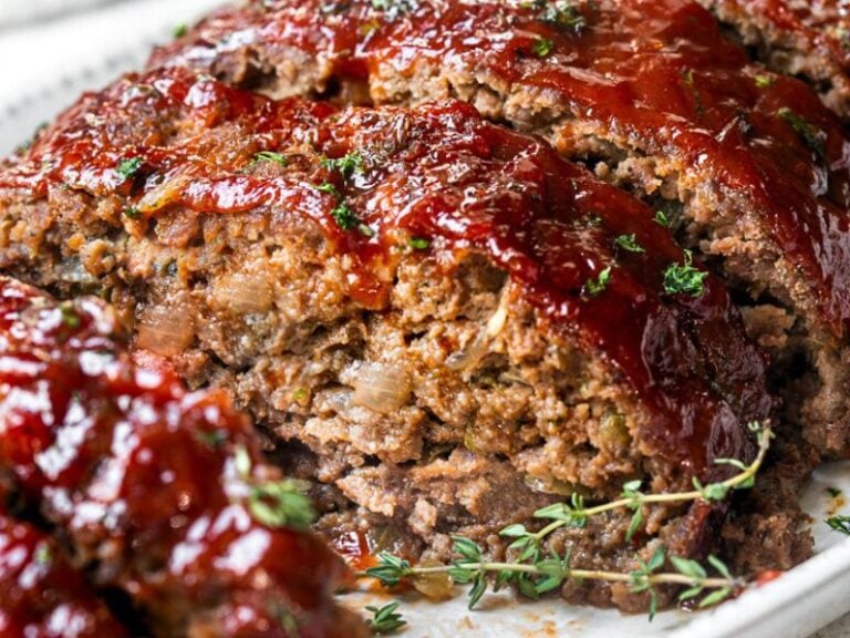 A photo of Ritz Cracker meatloaf on a plate with sweet and spicy glaze