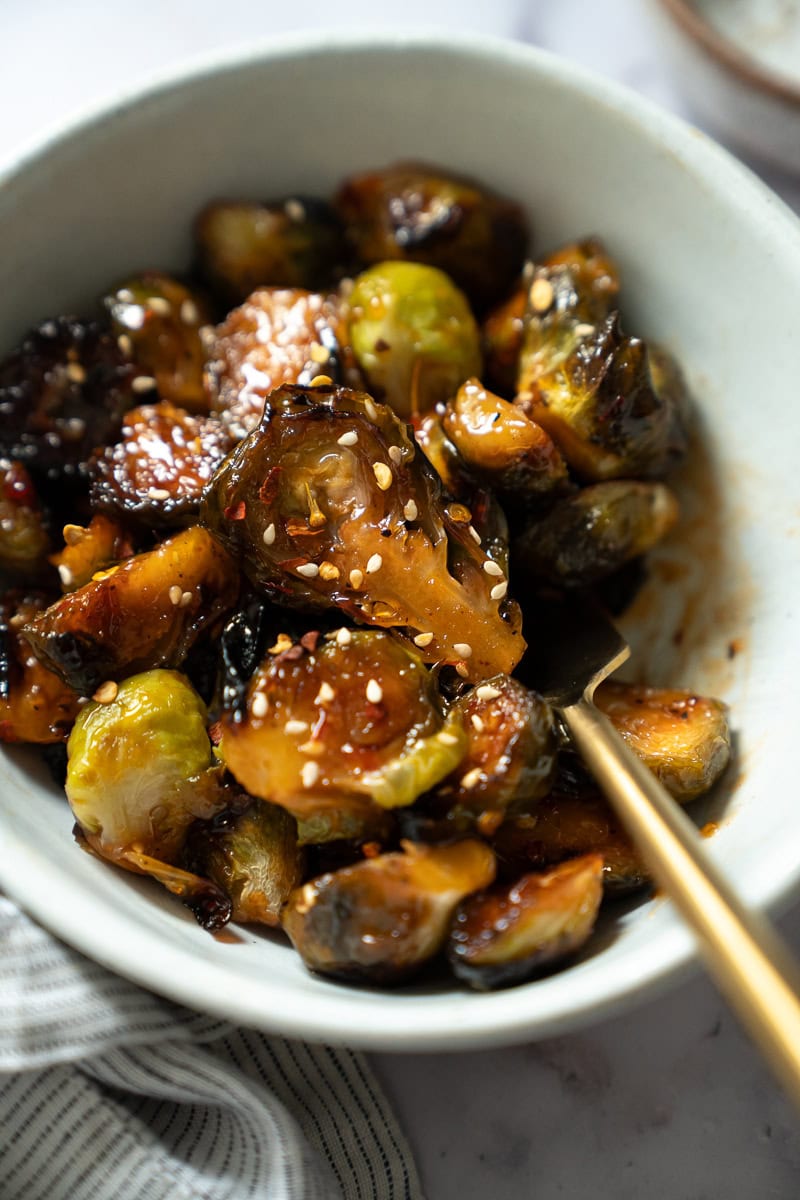 A bowl of sweet and spicy sweet chili sauce brussels sprouts