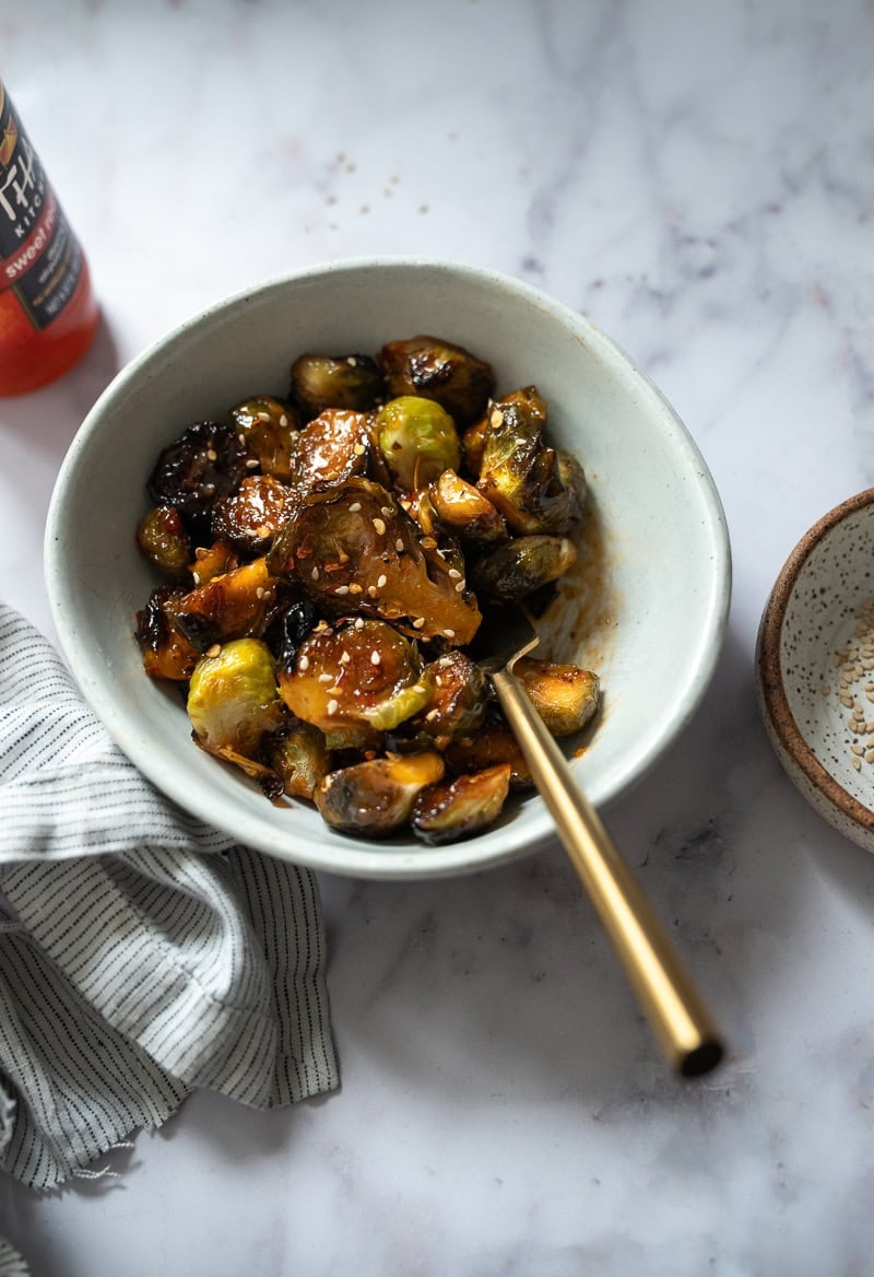 A bowl of roasted brussel sprouts bowl of roasted brussel sprouts and sweet chili glaze A bowl of roasted brussel sprouts and sweet chili glaze