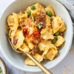 Bowl of creamy tortellini carbonara with bacon and parmesan