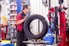 Auto mechanic inspecting tire in Whistler’s auto repair shop.