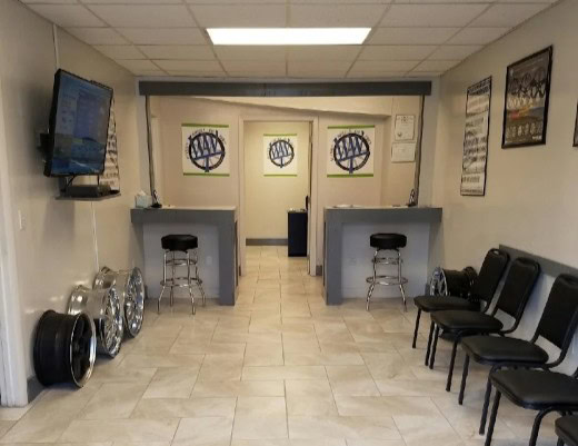 Interior of Winston Wheels & Tires showroom with seating and wheel displays.