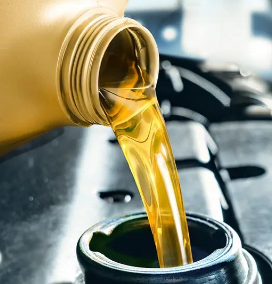 High-quality motor oil being poured into a car engine for maintenance.