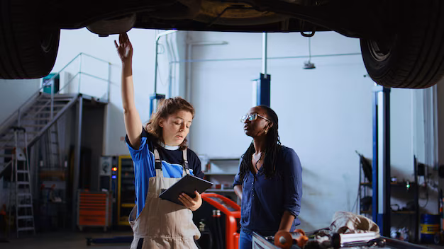 Female mechanics conducting undercarriage maintenance