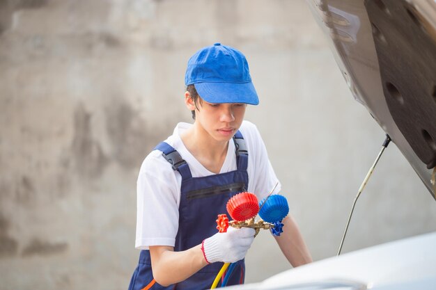 Mechanic checking car's cooling system with diagnostic tools