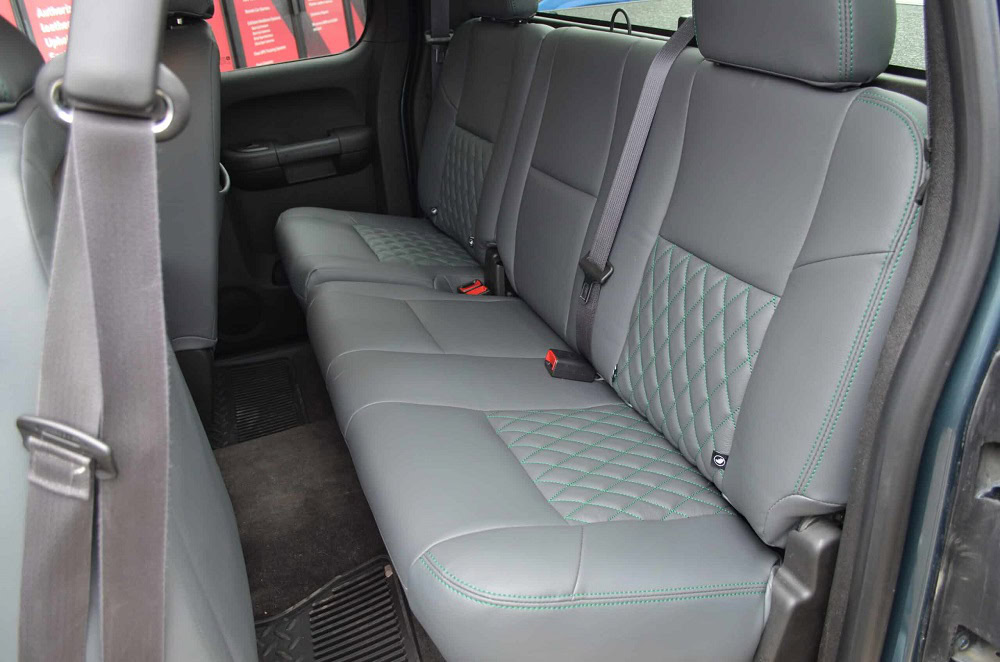 Custom car interior upholstery with quilted gray leather seats.