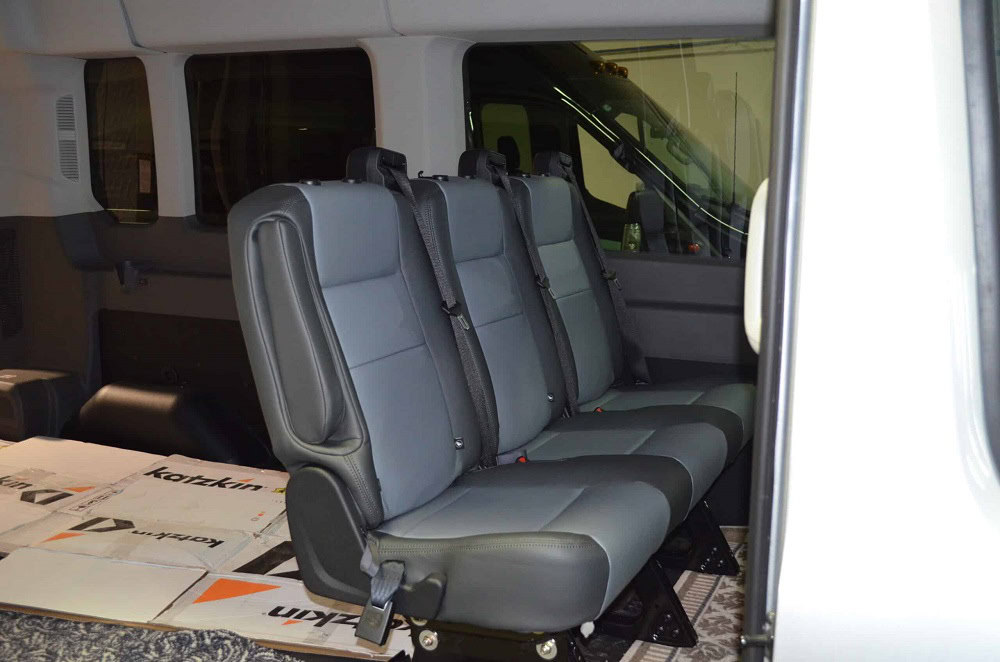 Gray van seats for comfortable passenger transport.