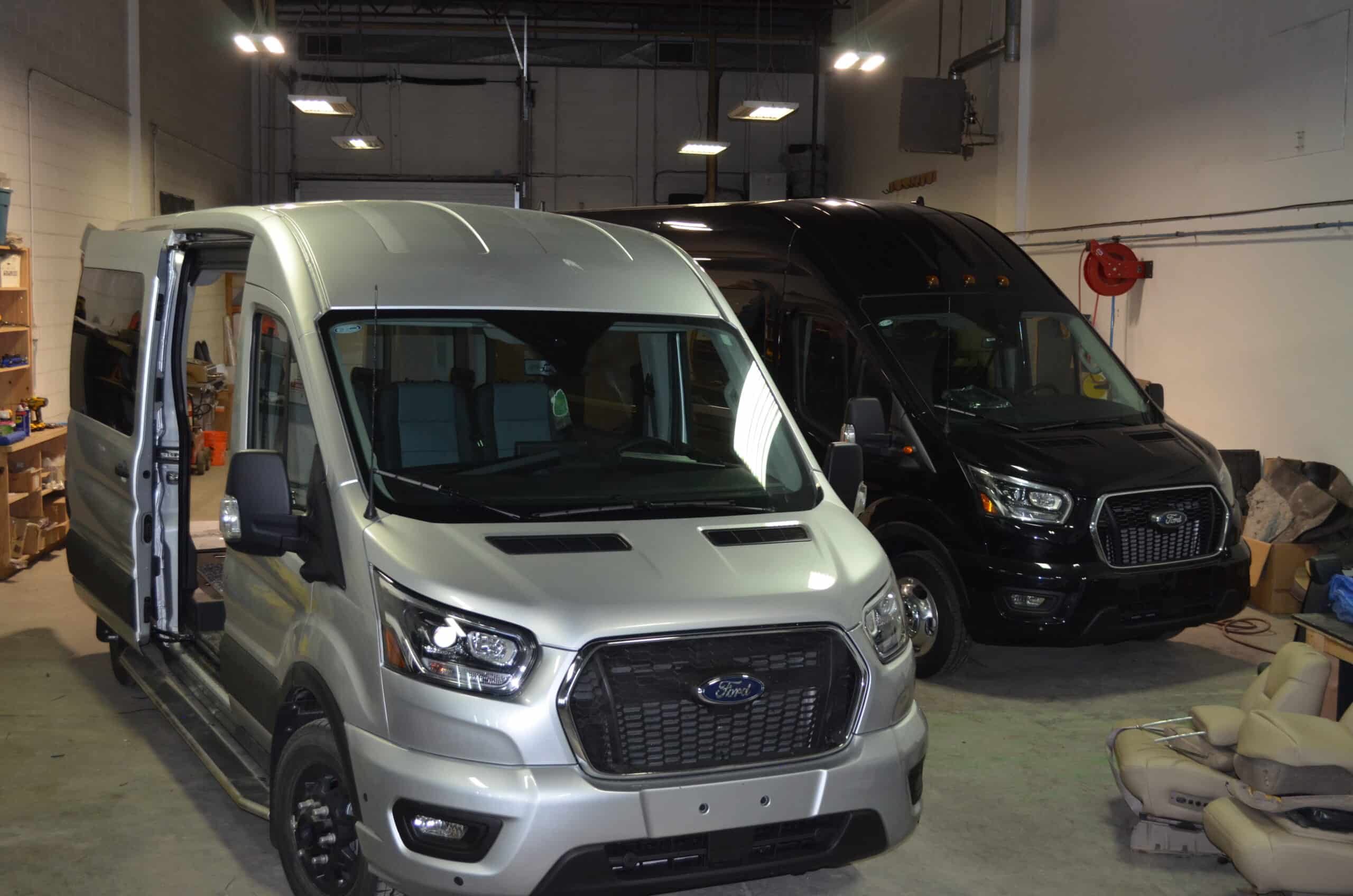 Ford Transit vans for vehicle customization and re-styling in a professional workshop setting.