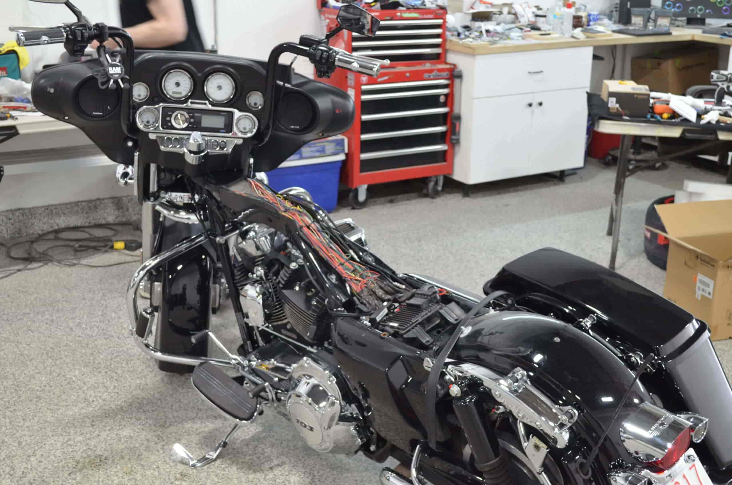 Motorcycle being restored with custom wiring and detailing at Wright ReStyling workshop.