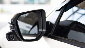 Side mirror of a modern vehicle, close-up shot.