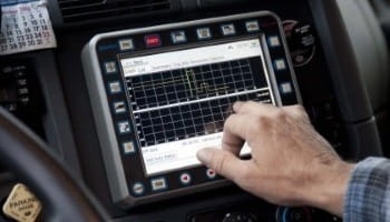 Automotive diagnostic scan on a car dashboard touchscreen.