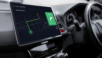 Tesla autopilot navigation system displayed on car dashboard screen.