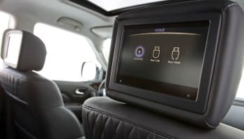 In-flight entertainment system with touchscreen monitor on airplane seatback.