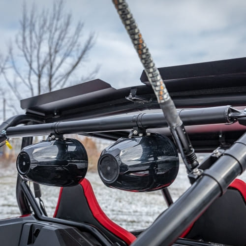 Custom off-road vehicle with upgraded speakers and roof rack for adventure trips.