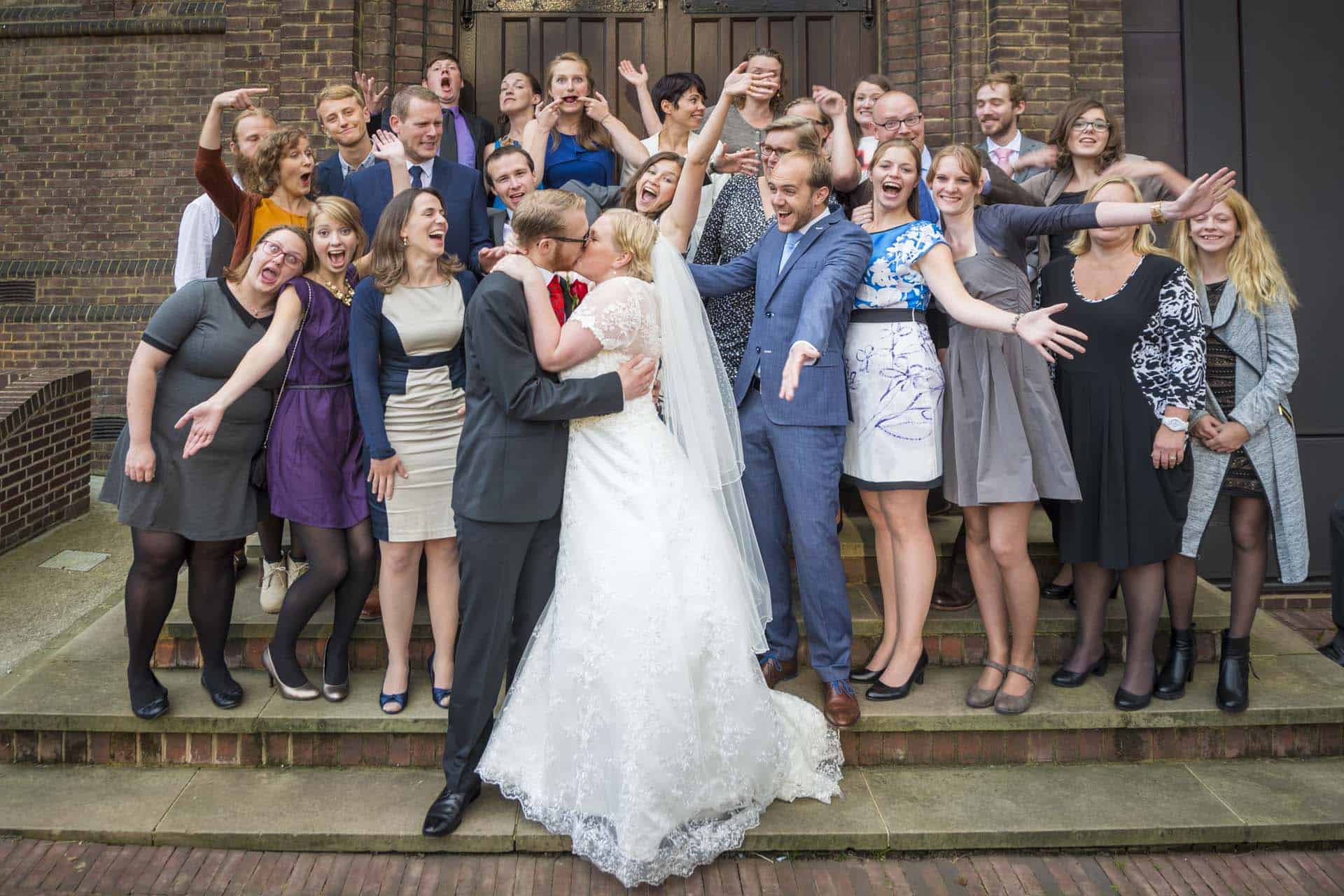 kissing couple with friends Camberwell wedding photographer article on extreme wide angle lenses