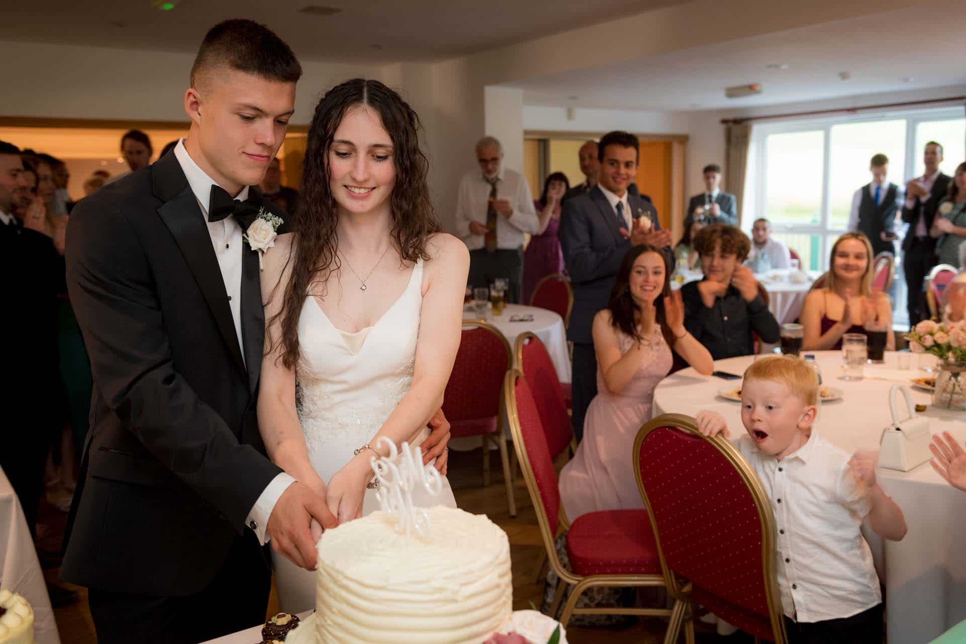 cake cutting Ollie & Sam Wallington Surrey wedding chipstead golf club reception Bromley kent wedding photographer 195311