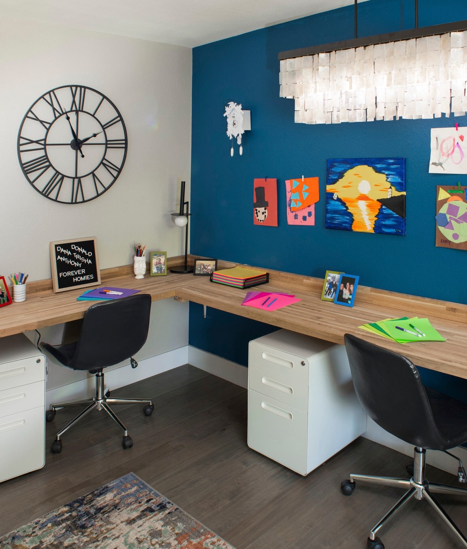 older kids study space with roller chairs and art on walls