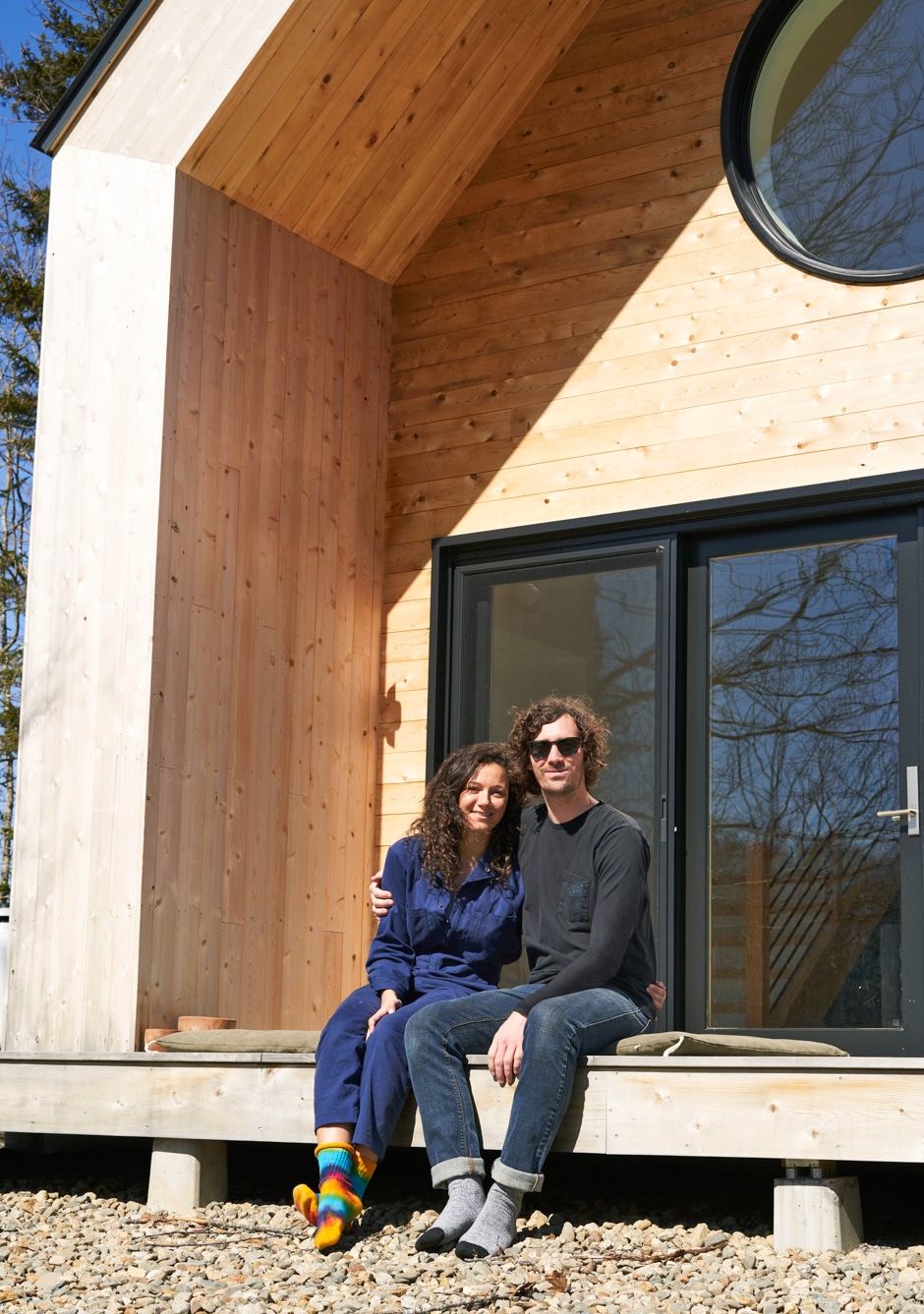 portrait of couple sitting on deck of maine cabin