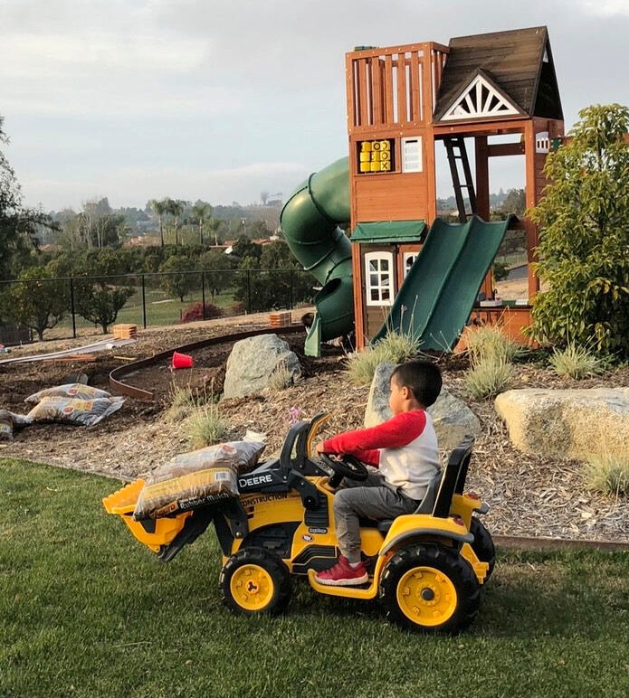 Kingsley moving mulch with tiny tractor