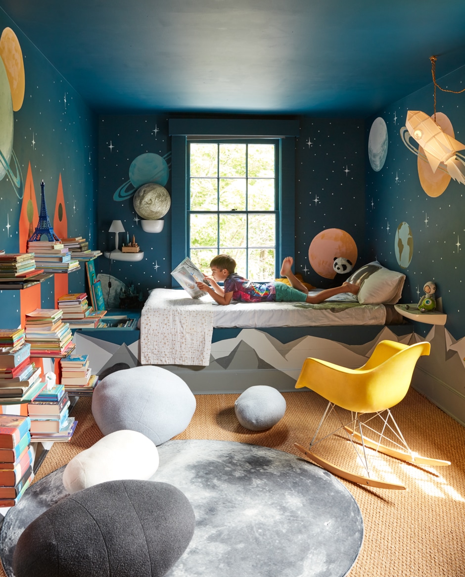 Henry lying on bed in space themed bedroom