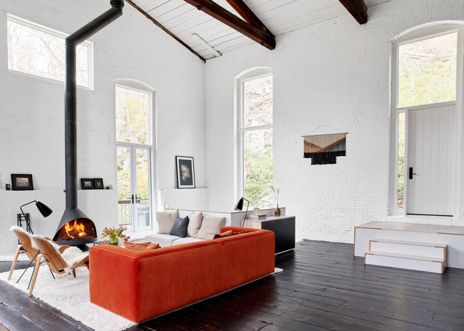 industrial high ceiling space living room with red couch