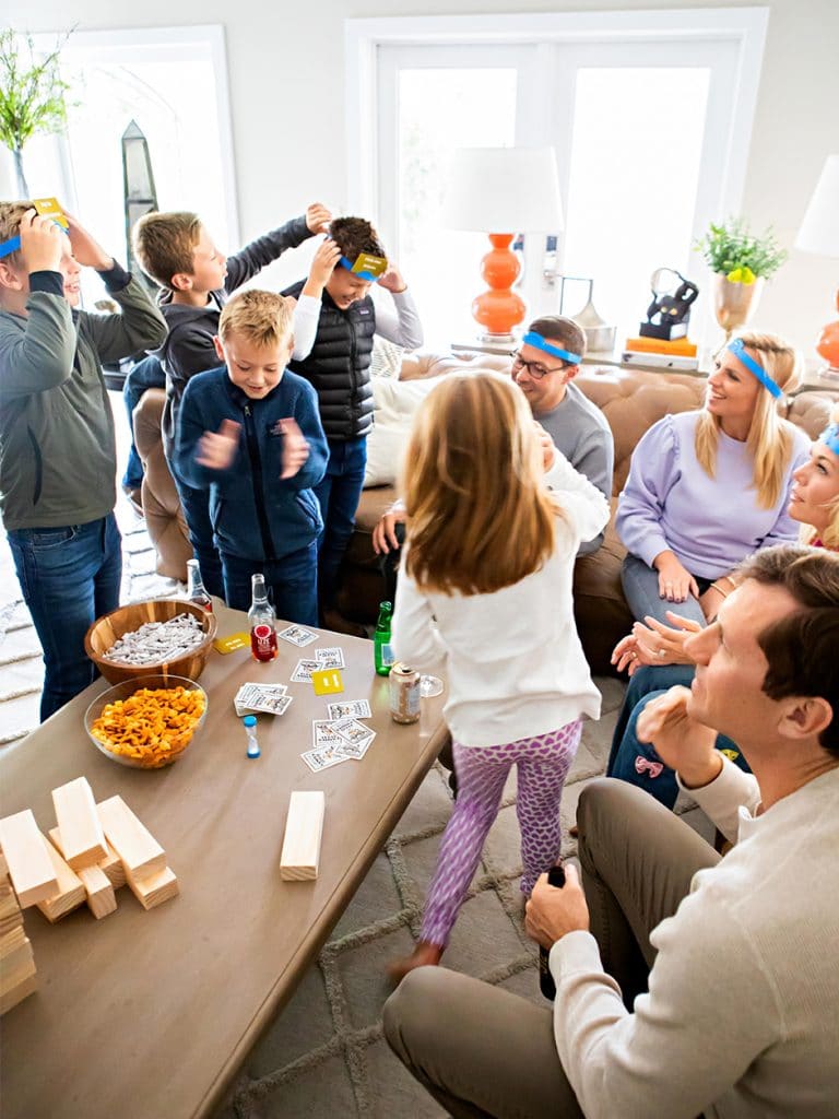 kids and adults playing lively games in living room, family game night ideas