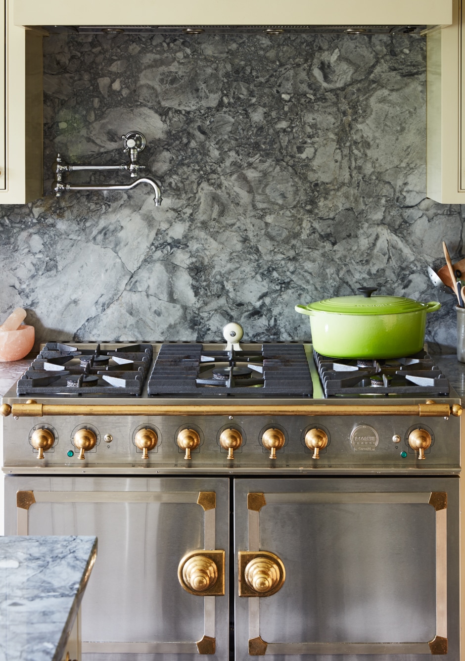 La Cornue range in silver and gold with marble backsplash