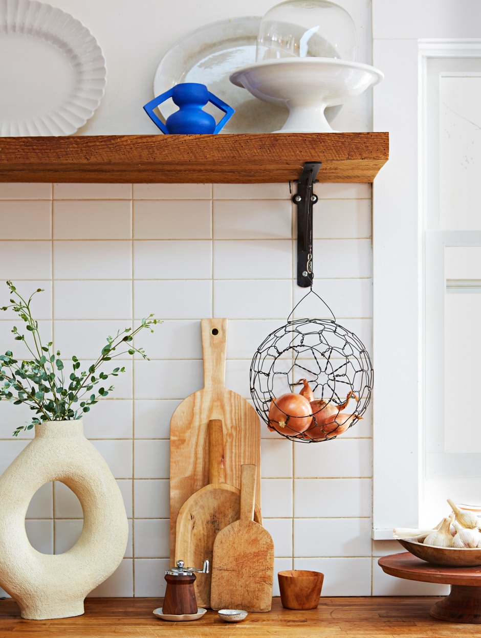 kitchen wooden counter and shelves with white tile backsplash