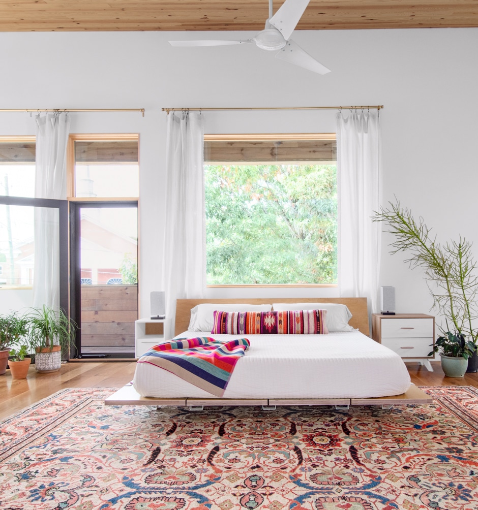 modern white bedroom with bohemian colorful accents
