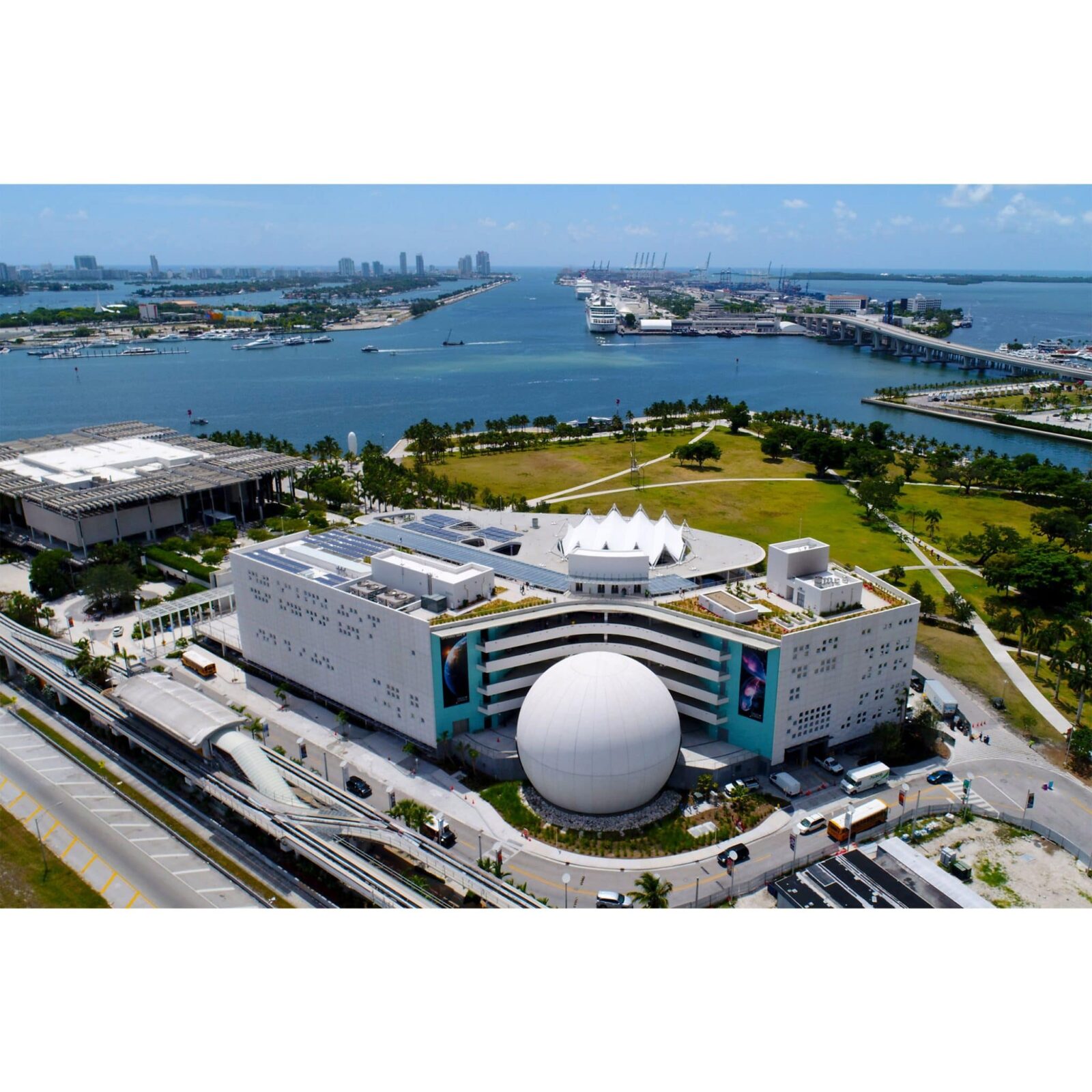 Aerial view of a large white building with a prominent white sphere