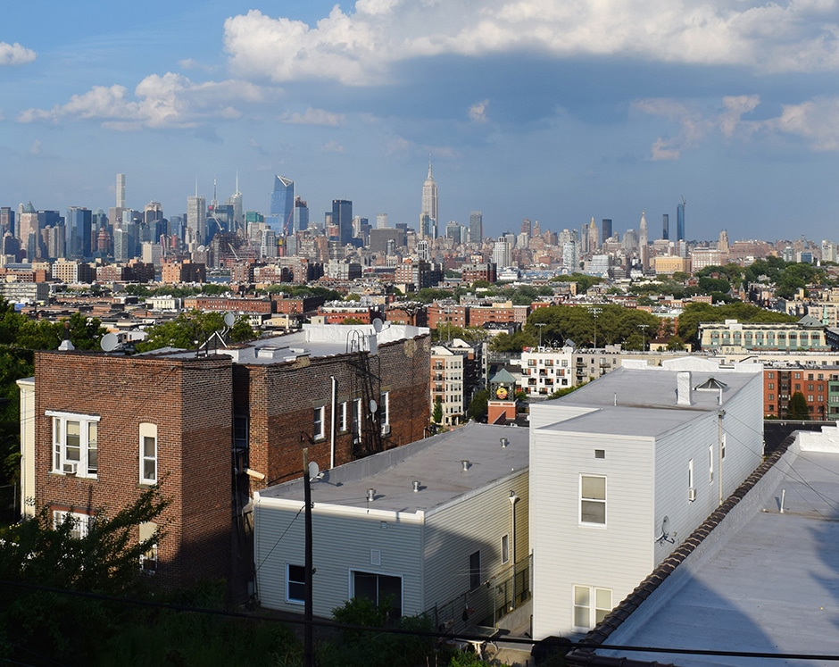 NYC skyline with foreground residential buildings and Empire State Building visible
