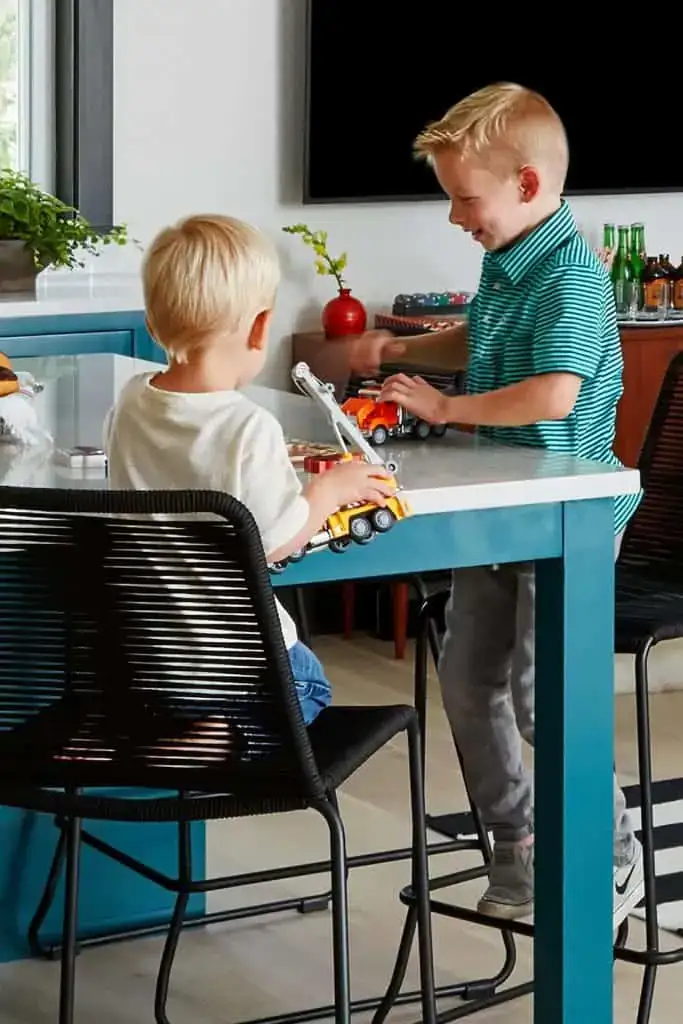 boys playing with trucks at island