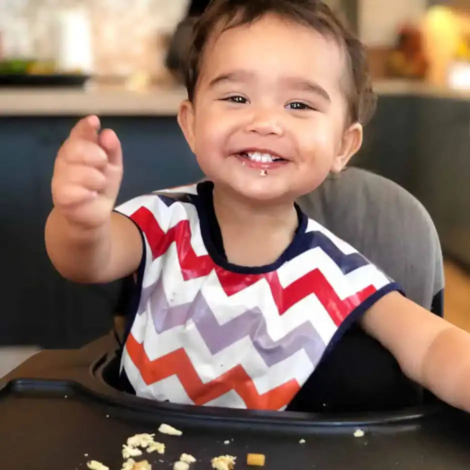 hayes eating snack at high chair