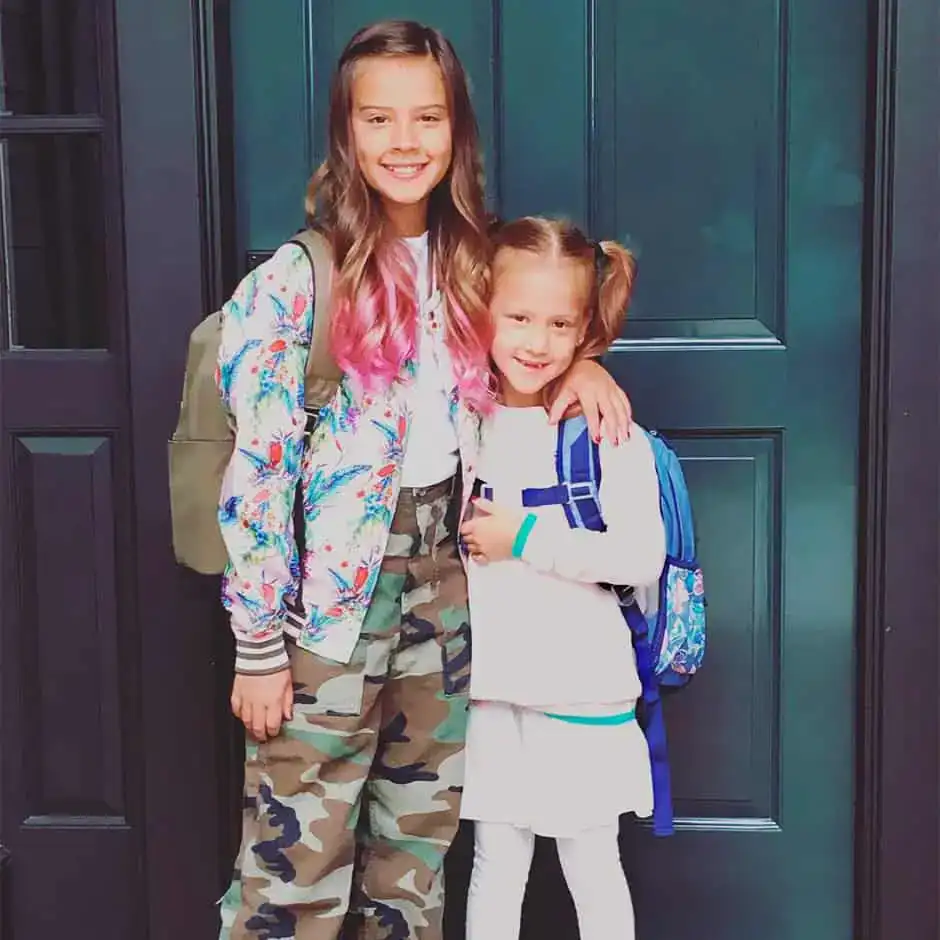 honor and haven dressed for school in front of door