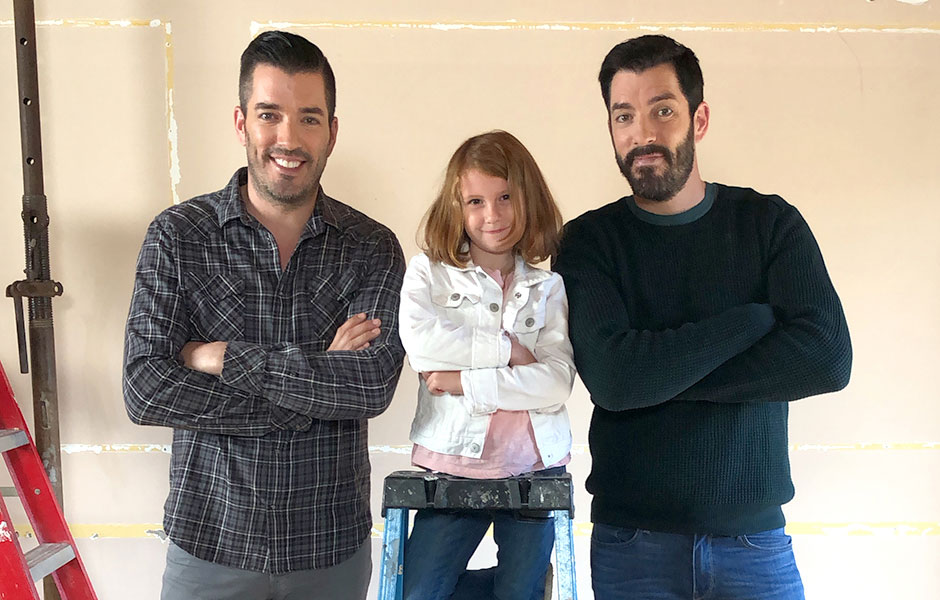 Drew and Jonathan and a girl posing in a room under renovation