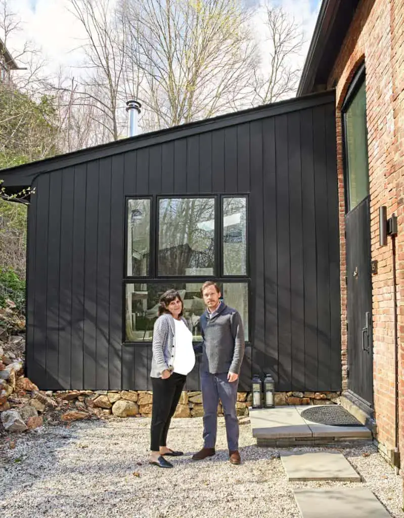 couple portrait in front of house on gravel walkway