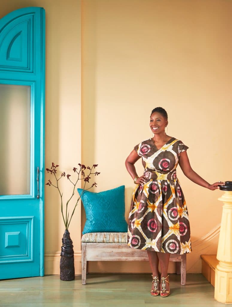 Malene standing in yellow and turquoise entryway