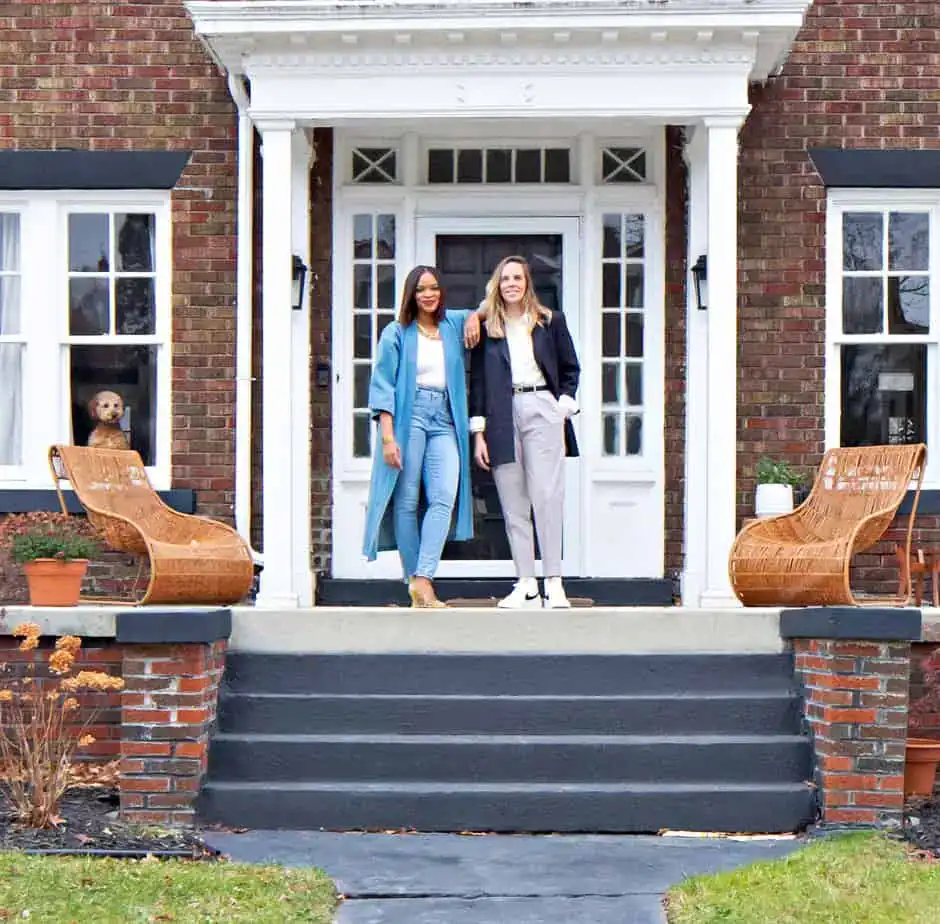 Candace and Pippa standing on steps of brick house