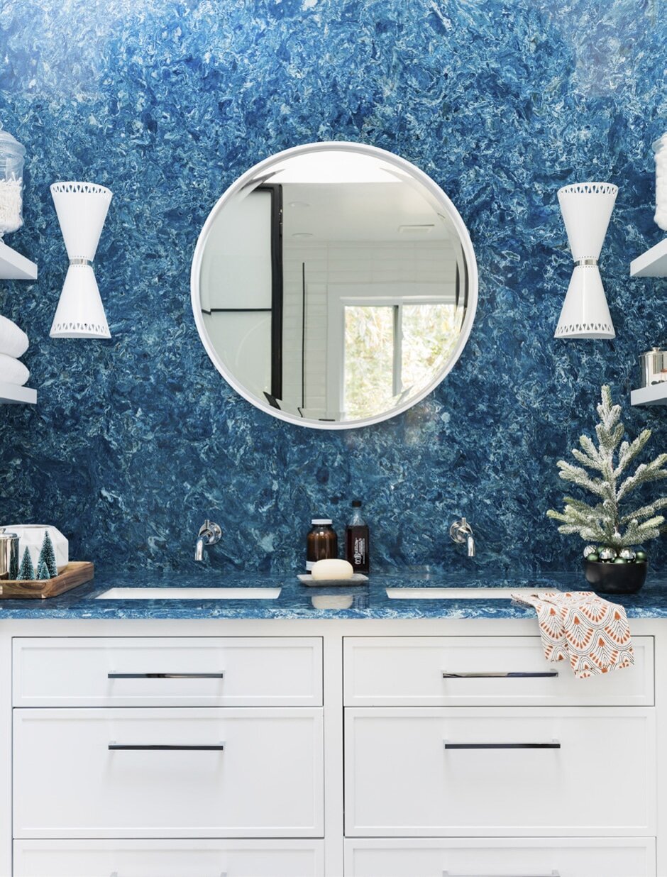 bathroom with white cabinets and turquoise wall and counter top
