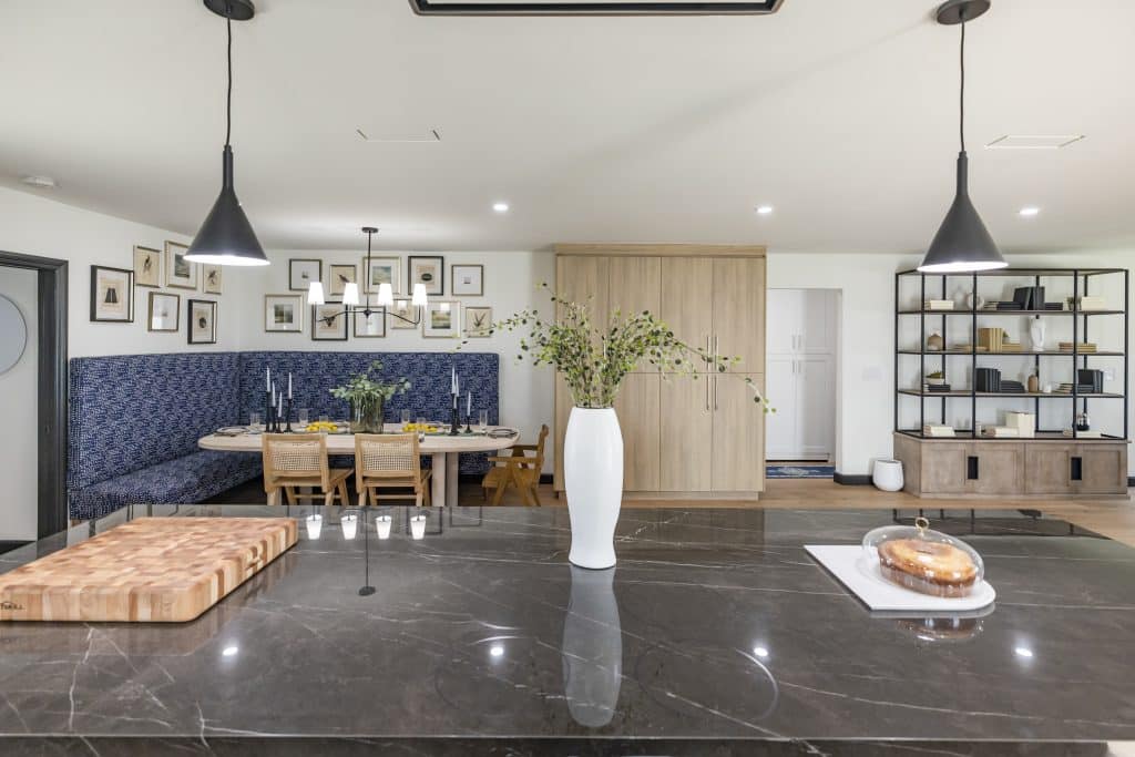 Kitchen island with black marble countertop and dining nook