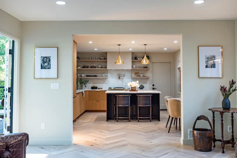 Kitchen with black island and gold pendant lights
