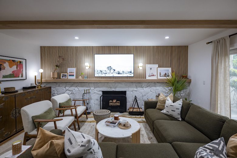 Cozy living room with green sectional and stone fireplace