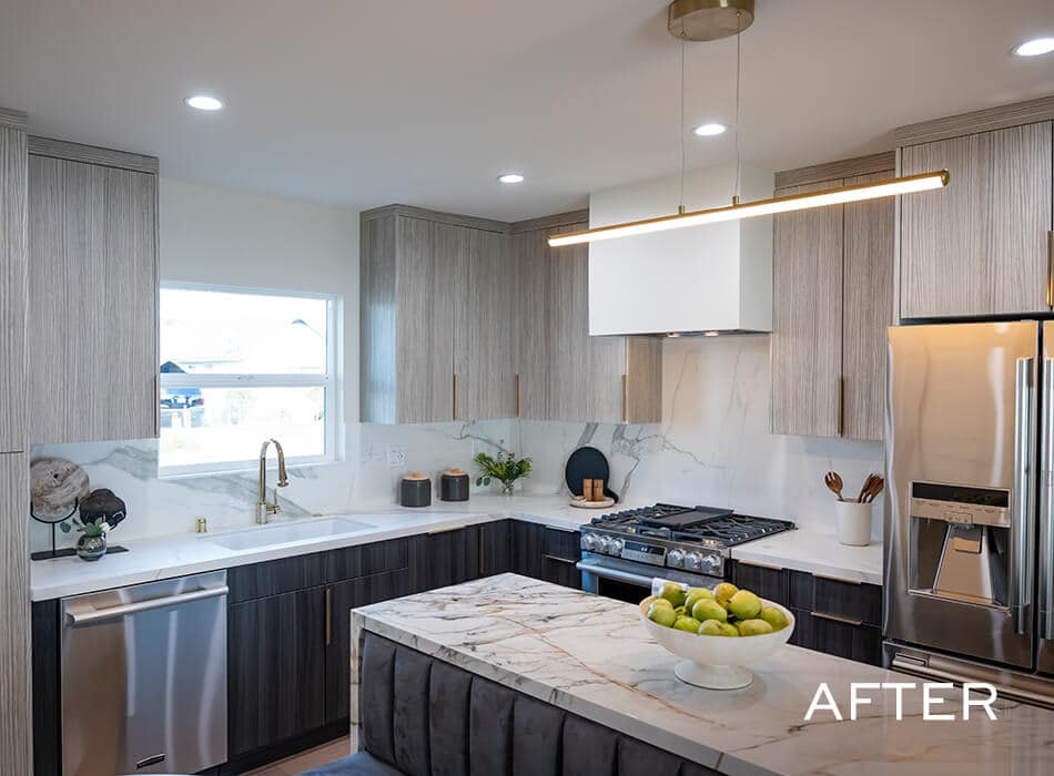 Modern kitchen with marble island, wood cabinets, and stainless appliances